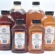 light and dark raw infused honey in 1 2 and 5 pound bottles
