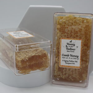 2 5 ounce mini comb honey in plastic cases in front of white background