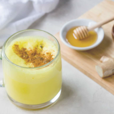 turmeric milk and honey in mug