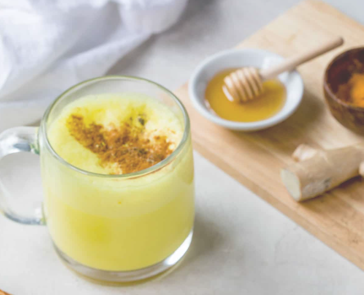turmeric milk and honey in mug