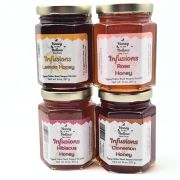 Rose, hibiscus, lemon and cinnamon honey stacked in front of white background